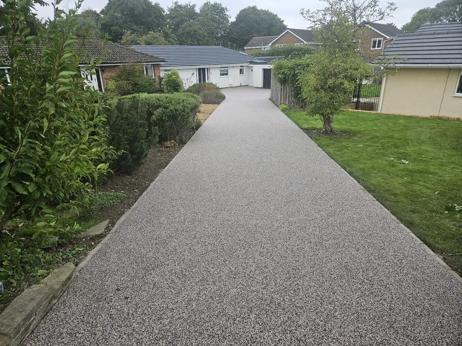 Rock Pool resin bound driveway, permeable and hand-trowelled, sweeping to a bungalow in Neston, Wirral